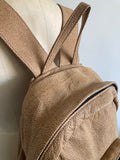 textured tan leather backpack