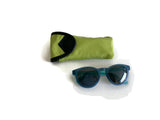 Blue sunglasses with a green case on a white background